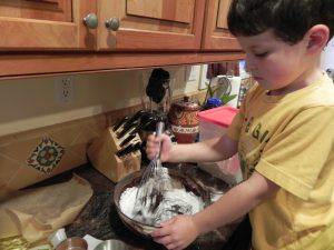kid mixing brownie batter